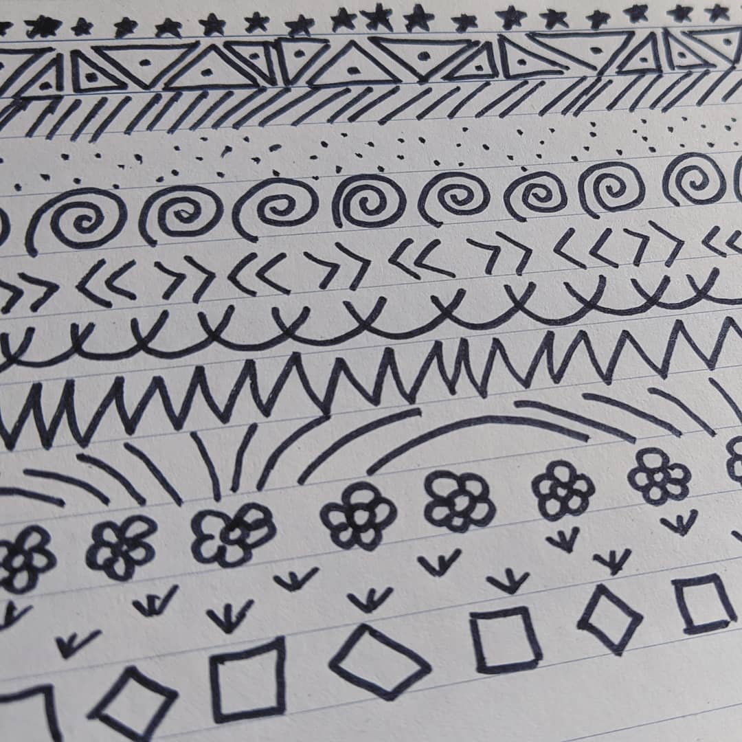 Simple doodles filling the lines on notebook paper