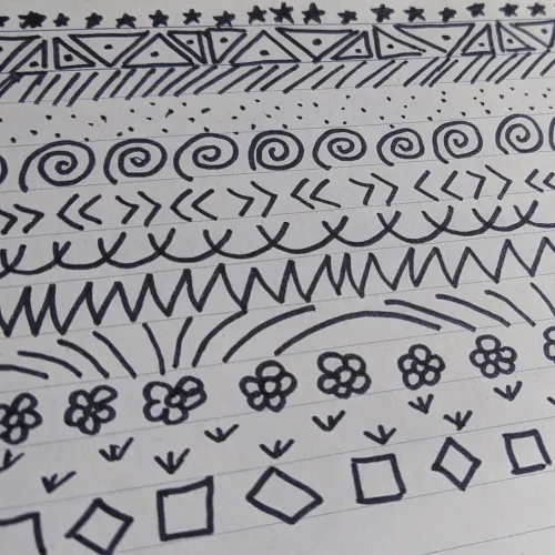 Simple doodles filling the lines on notebook paper